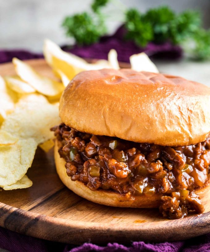 Sloppy joe sandwich on wooden plate