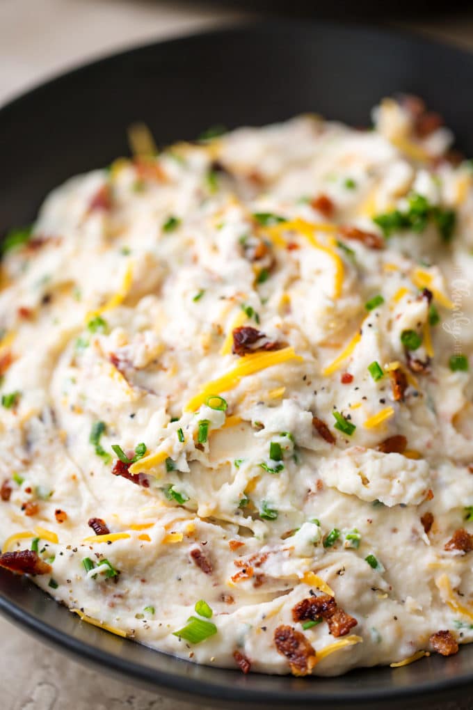 Loaded mashed potatoes in black bowl