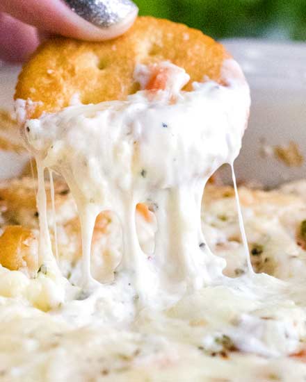 Creamy, cheesy and garlicky, this baked shrimp dip tastes like a dip-able version of shrimp scampi! #shrimp #dip #scampi #appetizer #partyfood #gameday #cheesy #easyrecipe #partyrecipe