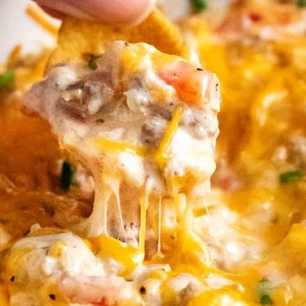 The perfect dip for a party, this crockpot creamy sausage dip is zesty, cheesy, and made easily in the slow cooker! #rotel #sausage #creamy #cheesy #dip #party #gameday #tailgate #crockpot #slowcooker