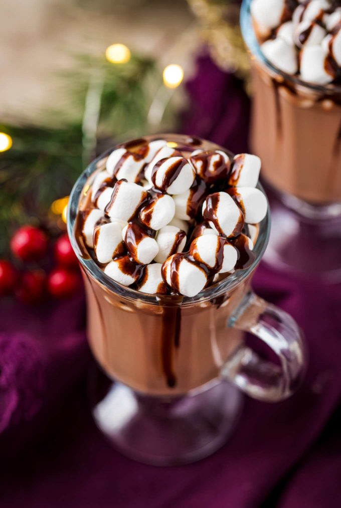 Mug of hot chocolate with marshmallows on top with chocolate syrup