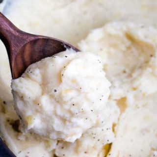 Creamy and rich, these mashed potatoes are heavy on the flavor and light on the work... with no boiling! Truly the BEST way to make homestyle mashed potatoes for a weeknight dinner or holiday meal! #thanksgiving #sidedish #mashedpotatoes #potatoes #crockpot #slowcooker #noboil