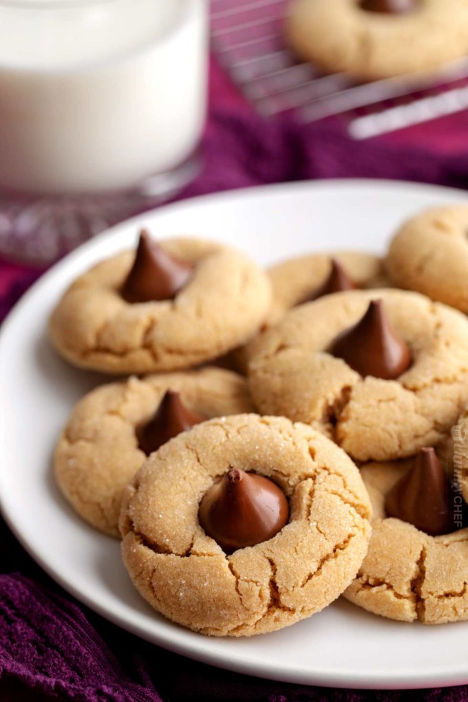 Plate of peanut butter blossoms cookies with milk