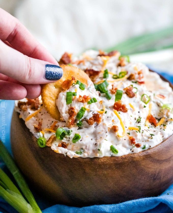 Serving bacon cheese dip with cracker