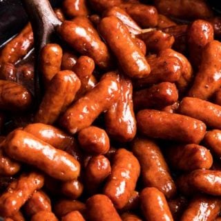 Always a crowd-pleaser, these Crockpot Little Smokies are slow cooked in a sauce made with beer, garlic, honey, brown sugar and bbq sauce. Perfect for game day, holidays, or any party! #littlesmokies #lilsmokies #partyfood #appetizer #recipe #easyrecipe #crockpot #slowcooker