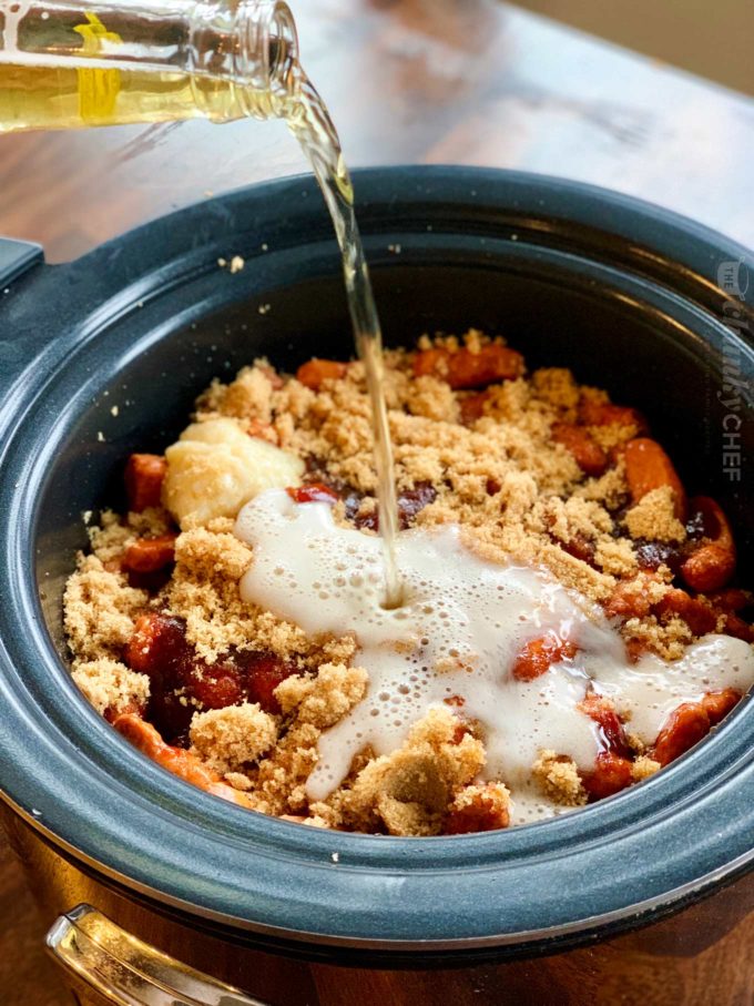 Pouring beer into crockpot little smokies