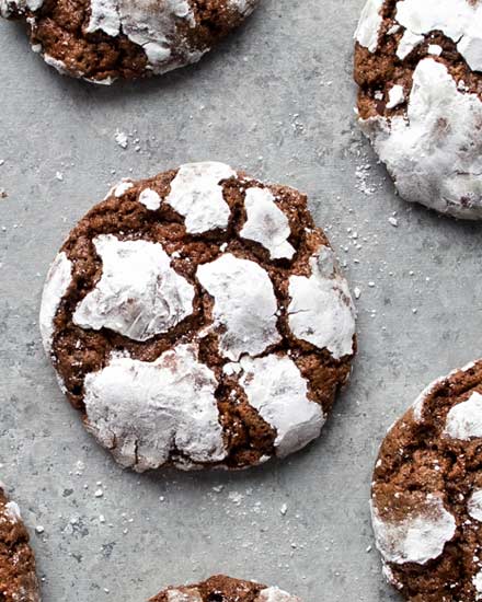 Fudgy and moist, these Chocolate Crinkle Cookies are a wonderful combination of cookies and brownies, and all with that classic crackly top that makes them a favorite for Christmas baking! #cookies #crinkle #Christmas #cookietray #chocolate #brownie #baking #dessertrecipe #cookierecipe #holidaybaking