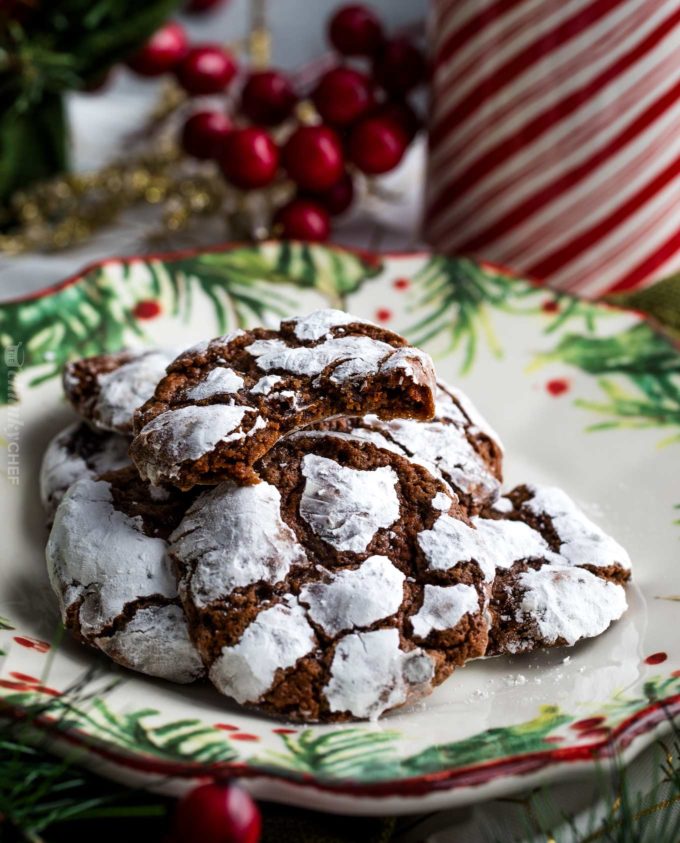 Bite taken out of chocolate crinkle cookie on Christmas plate