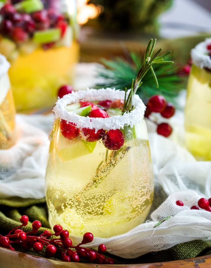 Sweet and festive, this white sangria recipe is full of Christmas cheer!  Easy to make for holiday entertaining, and can be made non-alcoholic as well! #sangria #white #christmas #holiday #winter #alcohol #drink #party #whitewine