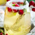 Sweet and festive, this white sangria recipe is full of Christmas cheer!  Easy to make for holiday entertaining, and can be made non-alcoholic as well! #sangria #white #christmas #holiday #winter #alcohol #drink #party #whitewine