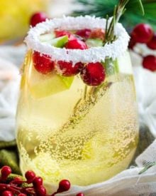 Sweet and festive, this white sangria recipe is full of Christmas cheer! Easy to make for holiday entertaining, and can be made non-alcoholic as well! #sangria #white #christmas #holiday #winter #alcohol #drink #party #whitewine