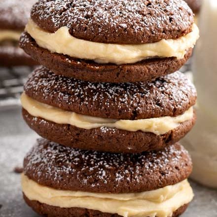 These whoopie pies are packed with classic Italian dessert flavors.  Soft and fluffy chocolate espresso cookies, sandwiched with a rich mascarpone kahlua frosting! #whoopiepies #cookierecipe #cookies #tiramisu #dessertrecipe #sandwichcookie #espresso #kahlua