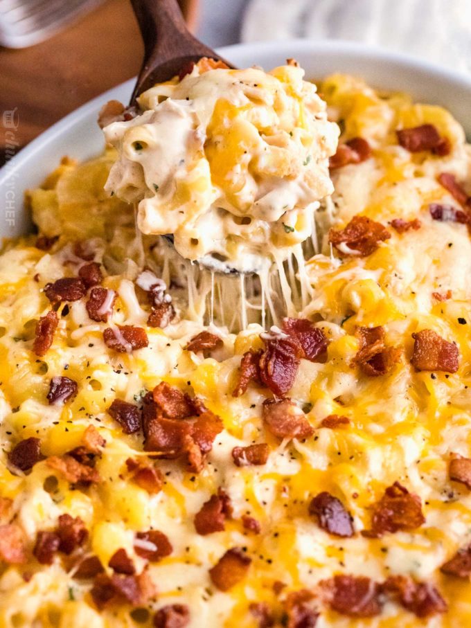 Serving spoon full of chicken bacon ranch mac and cheese casserole