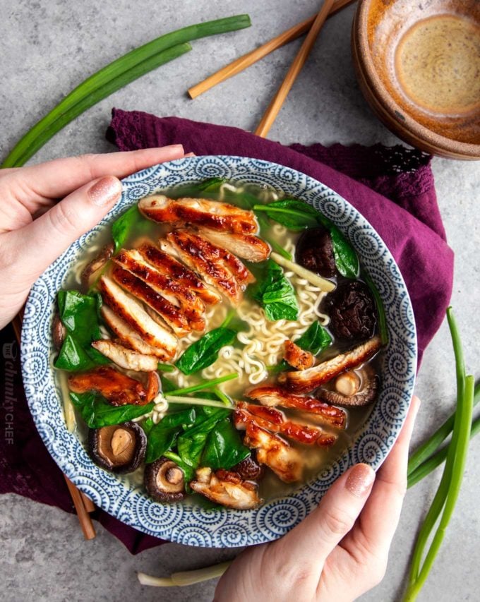 Holding a bowl of chicken ramen