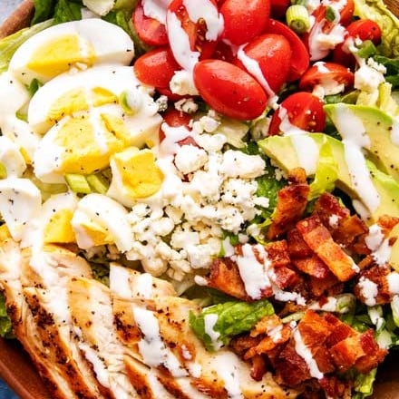 This classic Cobb salad is made with seared chicken breasts, crunchy bacon, sweet tomatoes, creamy hard-boiled eggs, buttery avocado and drizzled with a fantastic and low-carb homemade ranch dressing!  Perfect for Keto and low-carb living! #salad #cobb #lowcarb #keto #healthyrecipe #saladrecipe #ranchdressing #homemade #easyrecipe