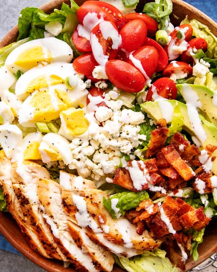 This classic Cobb salad is made with seared chicken breasts, crunchy bacon, sweet tomatoes, creamy hard-boiled eggs, buttery avocado and drizzled with a fantastic and low-carb homemade ranch dressing!  Perfect for Keto and low-carb living! #salad #cobb #lowcarb #keto #healthyrecipe #saladrecipe #ranchdressing #homemade #easyrecipe