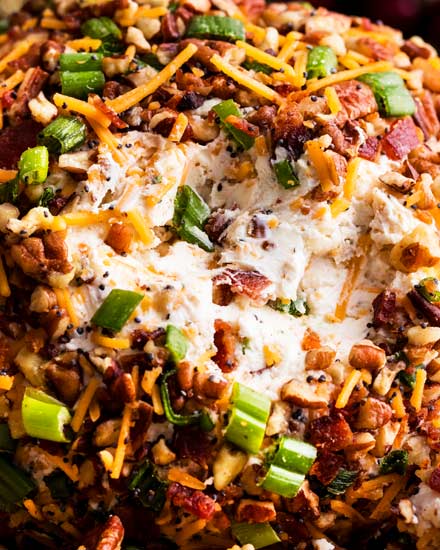 The Ultimate Bacon Ranch Cheese Ball is absolutely LOADED with bold flavors, and a perfect crowd-pleasing appetizer for any party! #appetizer #partyfood #cheeseball #baconranch #bacon #ranchrecipe #easyrecipe #makeahead