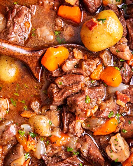 Crockpot Beef Bourguignon has melt in your mouth beef and hearty vegetables simmered all day in a rich red wine gravy!  The ultimate winter comfort food!  Slow cooker, oven, stovetop and instant pot directions! #beefstew #beefbourguignon #slowcooker #crockpot #comfortfood #dinner #easyrecipe #beef