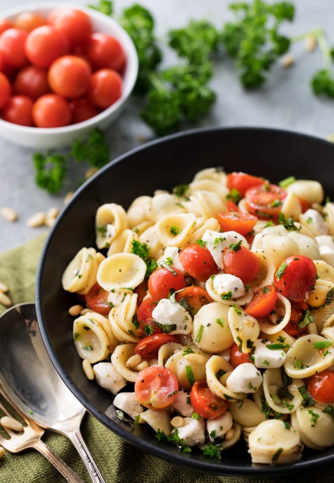 Caprese pasta salad in black bowl