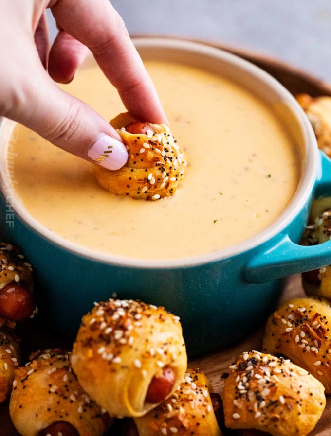 Dipping pigs in a blanket into beer cheese