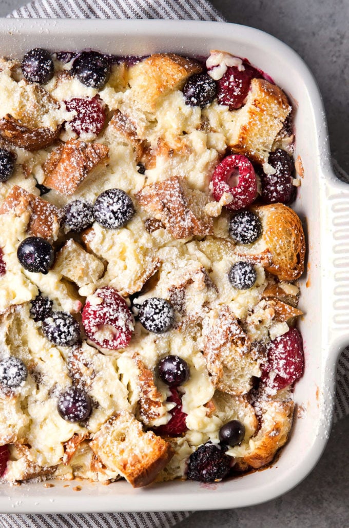 Overhead view of sweet breakfast bake in baking dish with powdered sugar