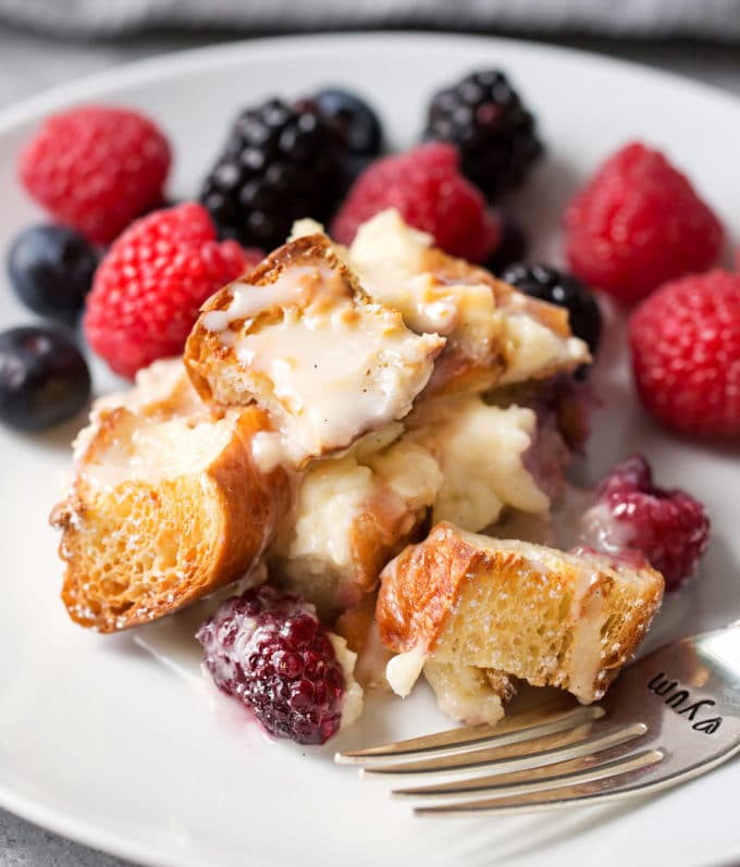 Sweet croissant breakfast casserole on plate with vanilla glaze