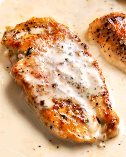 Tender chicken breasts smothered in a rich garlic cream sauce, all made in the same pan, and ready in less than 30 minutes! #easyrecipe #weeknightdinner #dinnerrecipe #chicken #garlic #creamy #onepan #onepot #skilletmeal