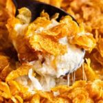 Funeral potatoes, aka Cheesy Potato Casserole, the hot side dish that EVERYONE loves. Perfect for any dinner, holiday or potluck!  Rich, cheesy and creamy hashbrown potatoes topped with buttery cornflakes and baked until golden and crispy! #potatoes #cheesy #potatocasserole #funeralpotatoes #partypotatoes #sidedish #potluck #holiday #hashbrown #baked #casserole