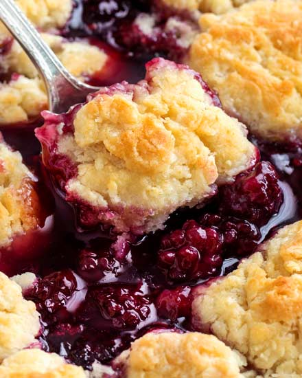 This easy summer blackberry cobbler is made with fresh berries and a sweet biscuit-like topping! Top with ice cream and enjoy! #cobbler #dessert #easyrecipe #blackberry #summerrecipe #berries #homemade