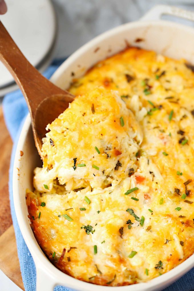 Serving a scoop of breakfast casserole from baking dish