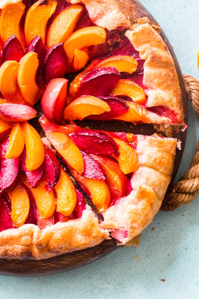 Serving a slice of stone fruit galette