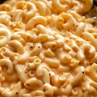 Slow Cooker Mac and Cheese is ultra creamy, and SO easy! No boiling pasta, no velveeta, and no condensed soups needed. Perfect side dish or kid-friendly dinner option! #macandcheese #macaroniandcheese #crockpot #slowcooker #easyrecipe #sidedish #potluck #holiday
