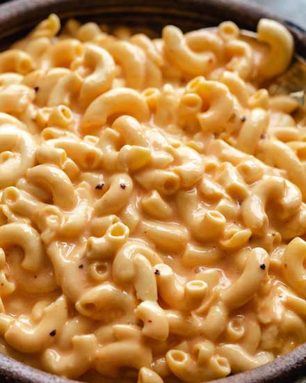 Slow Cooker Mac and Cheese is ultra creamy, and SO easy!  No boiling pasta, no velveeta, and no condensed soups needed.  Perfect side dish or kid-friendly dinner option! #macandcheese #macaroniandcheese #crockpot #slowcooker #easyrecipe #sidedish #potluck #holiday