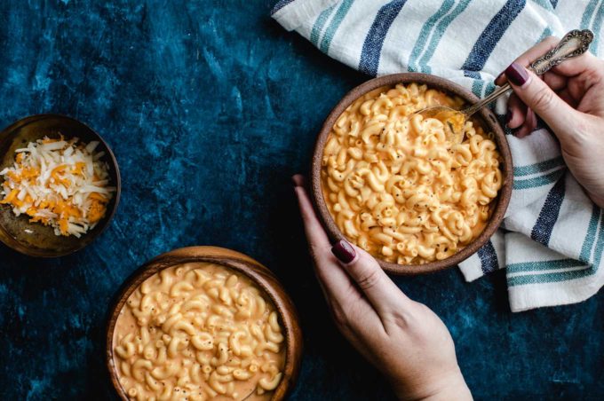 Holding a bowl of crock pot mac and cheese