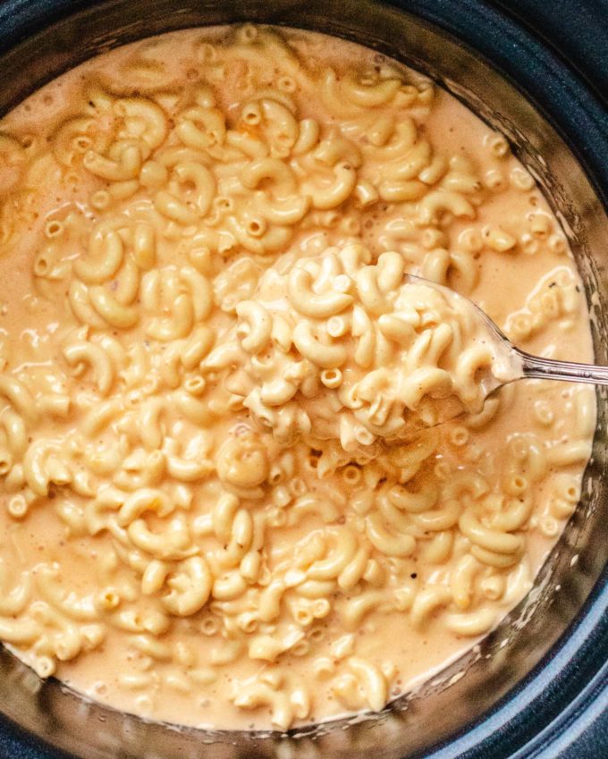 Serving spoon of crock pot mac and cheese