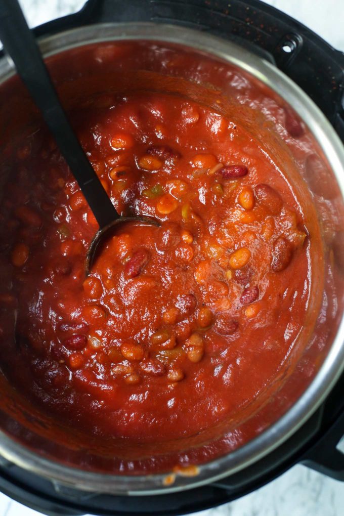 Incredibly flavorful and hearty, this 3 bean chili is made in the Instant Pot and ready in no time!  Vegetarian chili is perfect for game day, tailgating, and weeknight dinners! #chili #vegetarian #instantpot #crockpot #slowcooker #beans #party #gameday