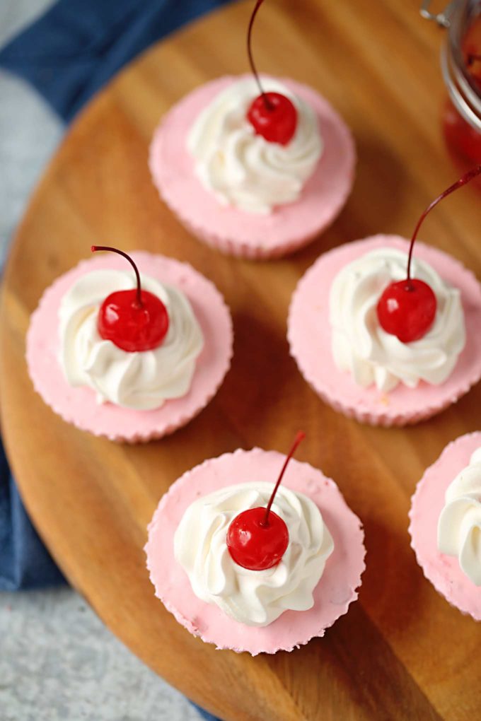 cherry no bake cheesecake on wooden board