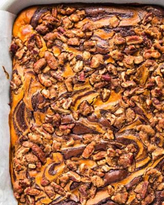 Fudgy brownie batter swirled together with creamy pumpkin cheesecake, then topped with a pecan streusel... it's the perfect Fall dessert! Easy to make, and oh so incredibly delicious! #brownies #pumpkin #cheesecake #Fall #autumn #dessert #easyrecipe #baking