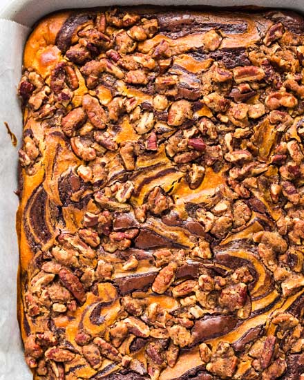 Fudgy brownie batter swirled together with creamy pumpkin cheesecake, then topped with a pecan streusel... it's the perfect Fall dessert!  Easy to make, and oh so incredibly delicious! #brownies #pumpkin #cheesecake #Fall #autumn #dessert #easyrecipe #baking