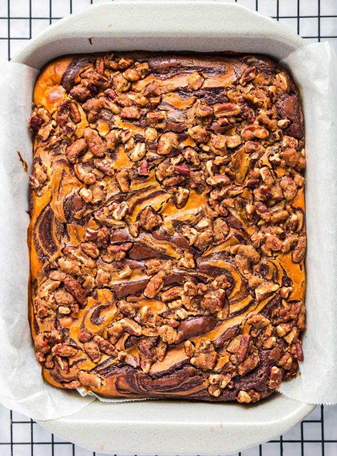 Overhead view of pumpkin cheesecake brownies in baking dish