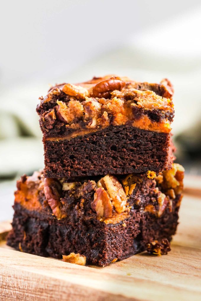 Fudgy brownie batter swirled together with creamy pumpkin cheesecake, then topped with a pecan streusel... it's the perfect Fall dessert!  Easy to make, and oh so incredibly delicious! #brownies #pumpkin #cheesecake #Fall #autumn #dessert #easyrecipe #baking