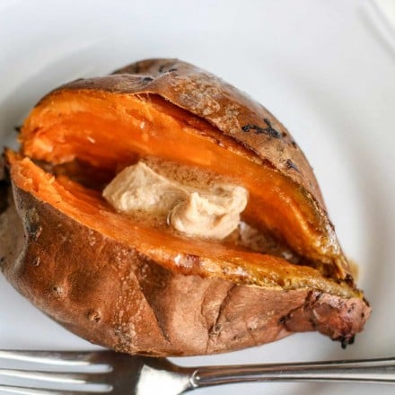 Baked sweet potato on plate with butter