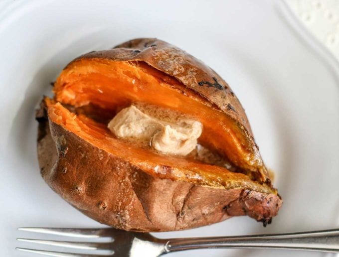 Baked sweet potato on plate with butter