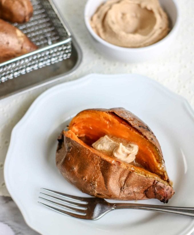 Perfectly baked sweet potatoes, every time!  Crispy on the outside and oh so fluffy on the inside, and with a quick 5 minute prep too!  Perfect side dish for dinner or a holiday event. #sweetpotato #sidedish #side #holiday #baked #airfryer #roasted #thanksgiving #recipe