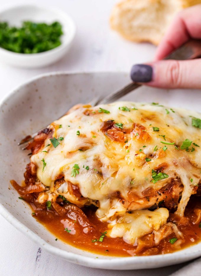 French onion baked chicken on white plate