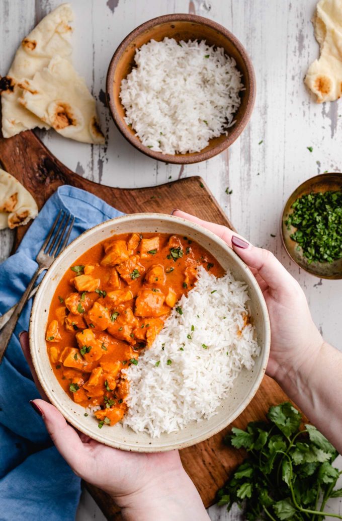 Holding a bowl of slow cooker chicken tikka masala