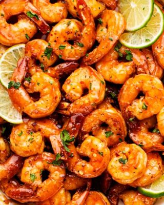 Spicy Honey Lime Shrimp, a quick, 15 minute one pan recipe that's perfect for weeknight dinner! Garlicky, sweet, and spicy, these shrimps are perfect as a main dish, taco filling, or on a salad! #shrimp #honeylime #spicy #15minutemeal #easyrecipe #quickdinner #weeknightrecipe #dinner #seafood