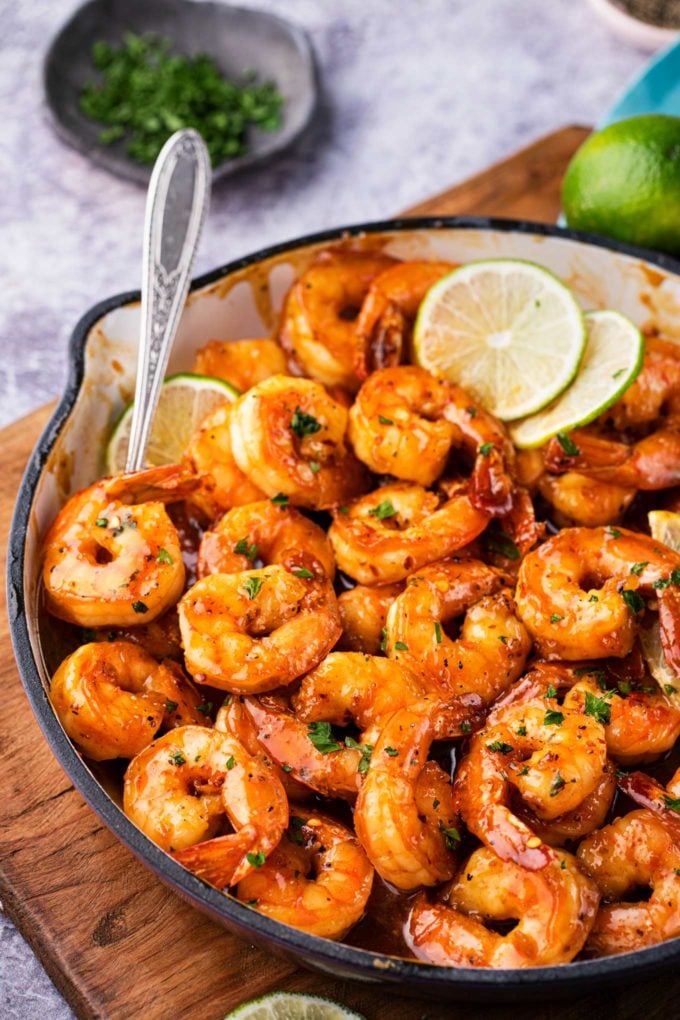 Spicy Honey Lime Shrimp, a quick, 15 minute one pan recipe that's perfect for weeknight dinner!  Garlicky, sweet, and spicy, these shrimps are perfect as a main dish, taco filling, or on a salad! #shrimp #honeylime #spicy #15minutemeal #easyrecipe #quickdinner #weeknightrecipe #dinner #seafood