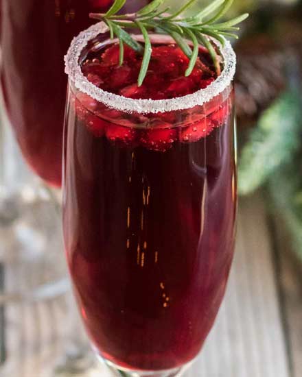 Refreshing and so quick and easy to make, these Pomegranate Mimosas are great for brunch, or a holiday party!  Tips on other flavor variations and how to make a pitcher for a large crowd! #mimosas #brunch #pomegranate #champagne #sparkling #holiday #cocktail #drinkrecipe