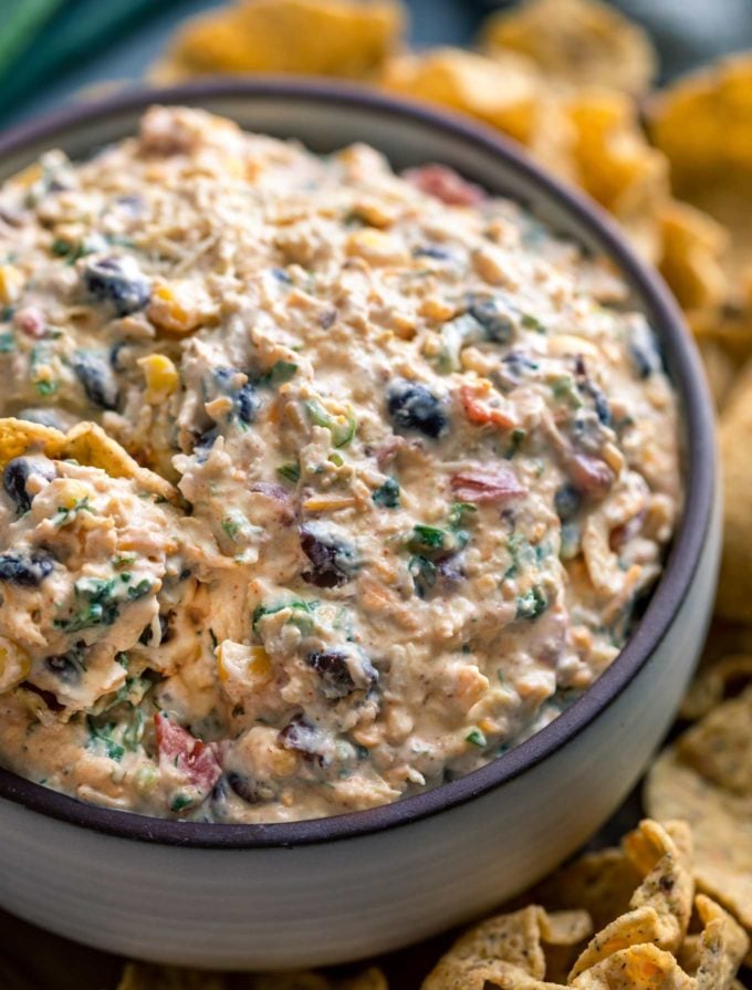 Loaded with bold flavors, this Southwestern Chicken Taco Dip is crazy addicting and always a crowd-pleaser!  Perfect to make-ahead and no-bake, which means you can be party ready in no time! #tacodip #chicken #makeaheadrecipe #dip #partyfood #appetizer #southwestern #nobake